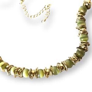 Green cat's eye and gold tone circle accent necklace